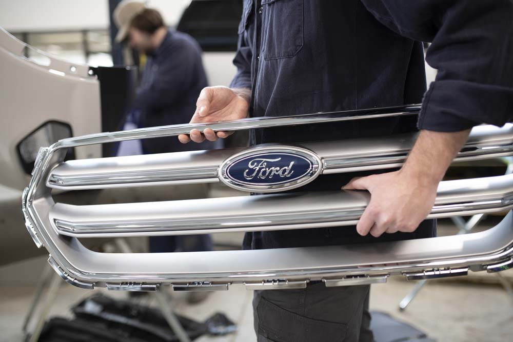 Ford Grille being replaced by service technician