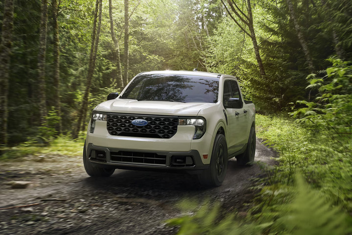 Tan Ford Maverick driving on a trail