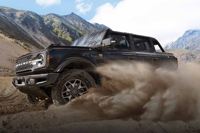 Black Ford Bronco drifting in sand