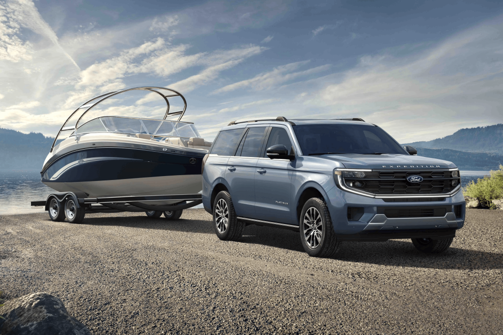 Blue 2025 Ford Expedition towing a boat