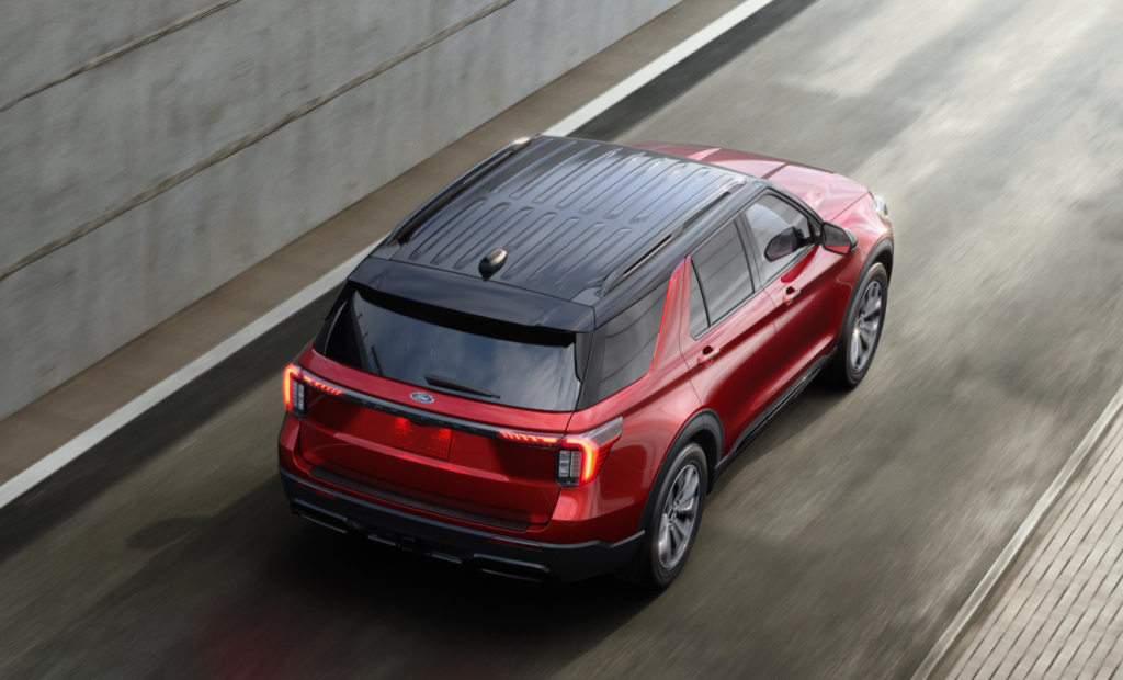 Red 2025 Ford Explorer driving away