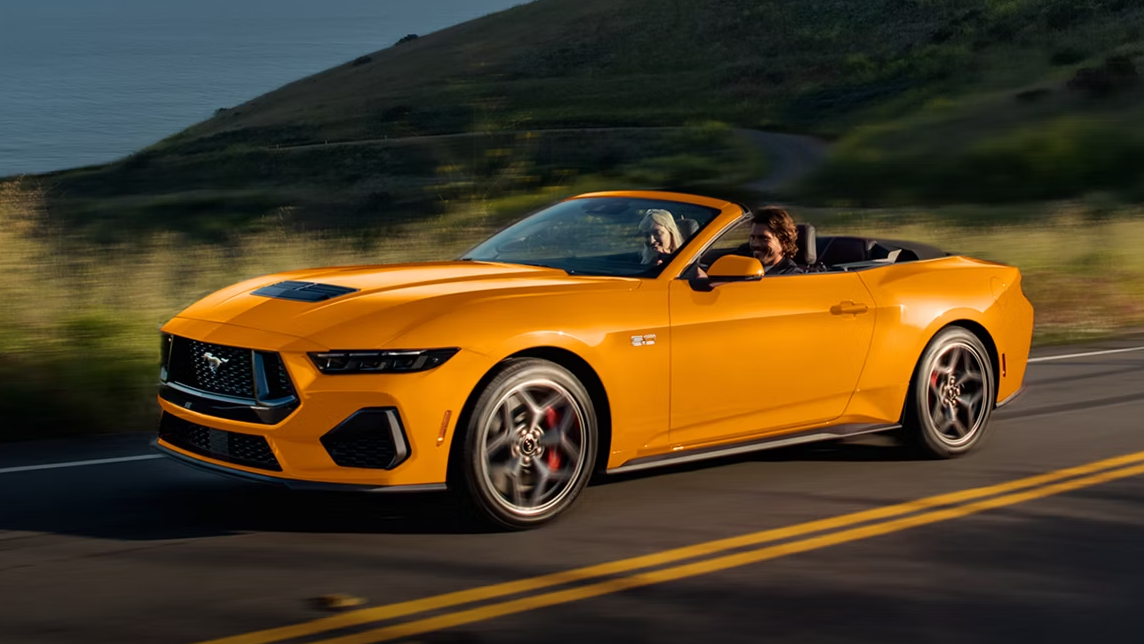 Orange 2026 Ford Mustang GT driving on the road